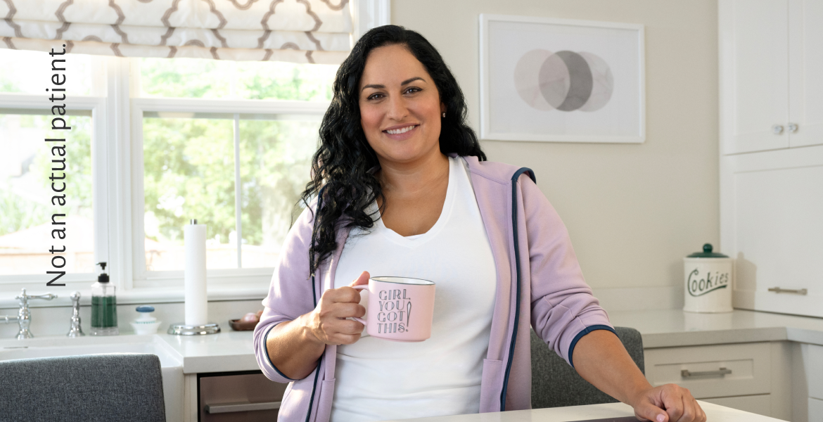 Woman facing forward and smiling confidently