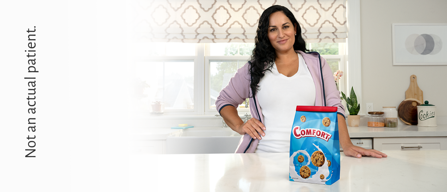 Woman in kitchen controlling her cravings by pushing away a bag of chocolates that says "boredom" on packaging